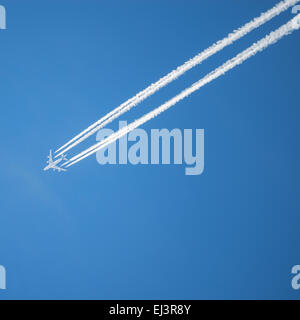 A long trail of jet plane on blue sky Stock Photo