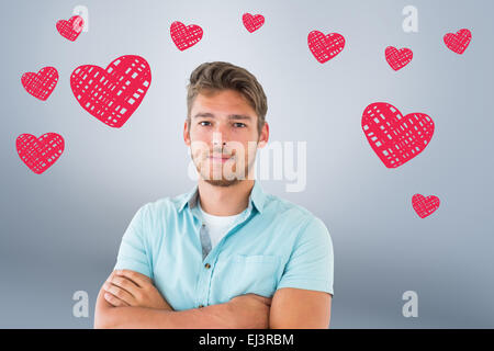 Composite image of handsome young man posing with arms crossed Stock Photo