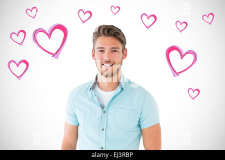 Composite image of handsome young man posing with hands in pockets Stock Photo