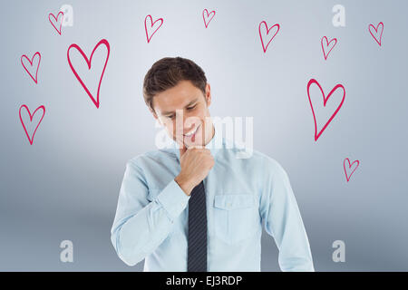 Composite image of thoughtful businessman with hand on chin Stock Photo