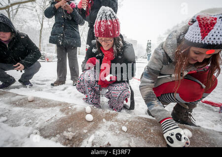 New York, USA. 20th March, 2015. Participants balance their eggs at Urban Shaman Donna Henes'  40th Annual 'Eggs on End: Standing on Ceremony' spring equinox celebration in Grand Army Plaza in Brooklyn in New York welcoming in the first day of spring on Friday, March 20, 2015.  At the precise moment of the Spring Equinox, this year at 6:45 PM, a raw egg can be stood on its end bringing good luck for the rest of the year. This year Mother Nature welcomed in Spring with with a snowstorm depositing three inches in New York. Credit:  Richard Levine/Alamy Live News Stock Photo