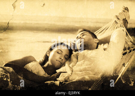 Composite image of peaceful couple napping in a hammock Stock Photo