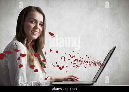 Composite image of businesswoman typing on her laptop Stock Photo