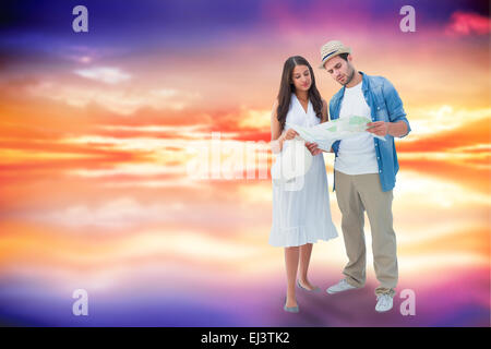 Composite image of lost hipster couple looking at map Stock Photo