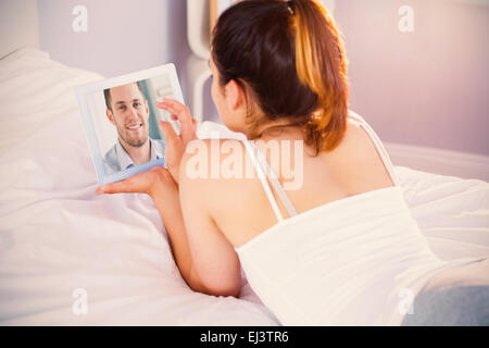 Composite image of businessman with rolled up sleeves on his laptop in his homeoffice Stock Photo