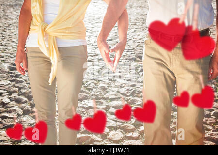 Composite image of happy senior couple touching hands Stock Photo