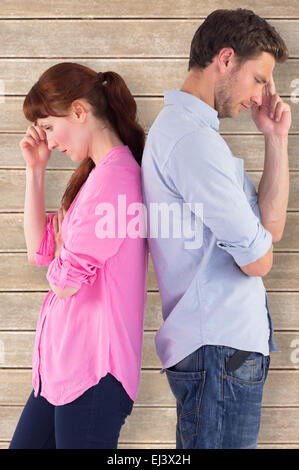 Composite image of irritated couple ignoring each other Stock Photo