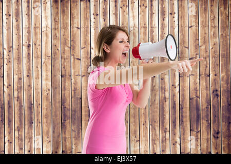 Composite image of angry woman with megaphone Stock Photo