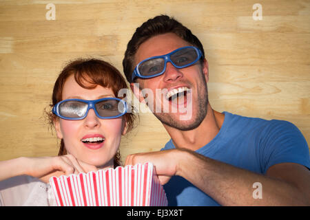 Composite image of couple enjoying a movie night Stock Photo