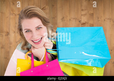 Composite image of overhead of a woman holding many shopping bags Stock Photo