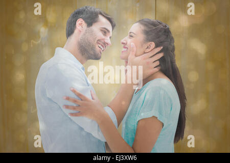 Composite image of attractive young couple about to kiss Stock Photo