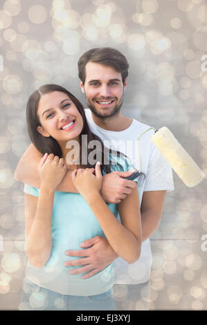 Composite image of happy young couple painting together Stock Photo