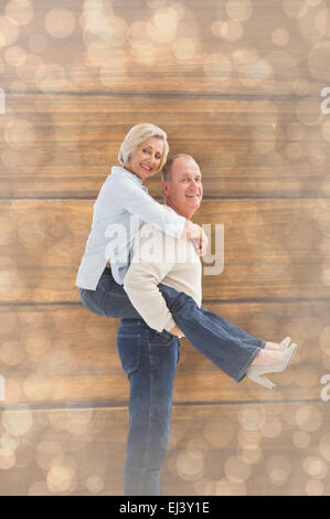 Composite image of happy mature couple having fun Stock Photo