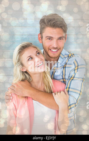 Composite image of attractive young couple smiling together Stock Photo