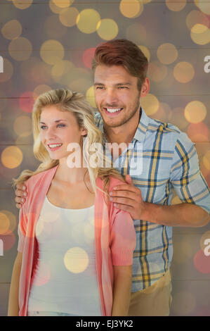 Composite image of attractive young couple smiling together Stock Photo