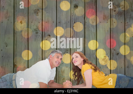 Composite image of casual couple lying and looking up Stock Photo