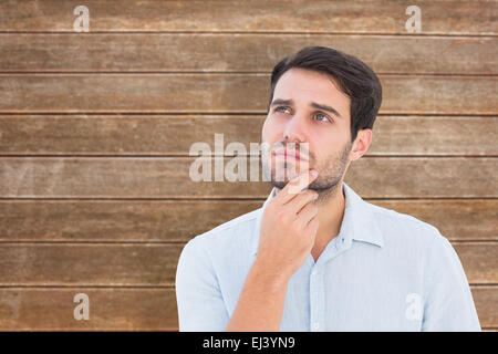Composite image of serious thinking man looking up Stock Photo