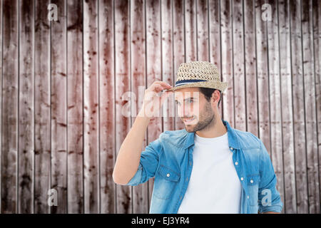 Composite image of handsome hipster wearing a trilby Stock Photo