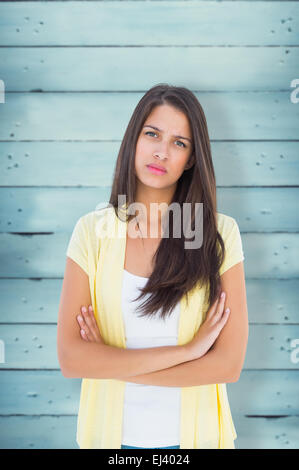 Composite image of frowning casual woman looking at camera Stock Photo
