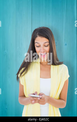 Composite image of shocked casual woman reading a text Stock Photo
