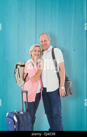 Composite image of smiling older couple going on their holidays Stock Photo