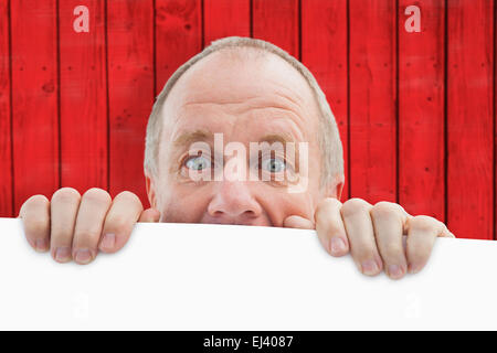 Composite image of mature man looking over card Stock Photo