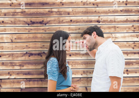 Composite image of angry man shouting at upset girlfriend Stock Photo