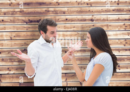 Composite image of angry brunette accusing her boyfriend Stock Photo