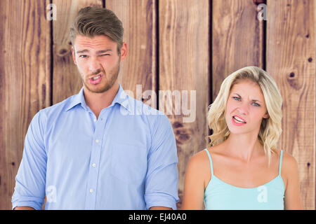 Composite image of young couple making silly faces Stock Photo