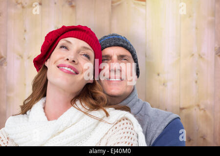 Composite image of happy couple in warm clothing Stock Photo