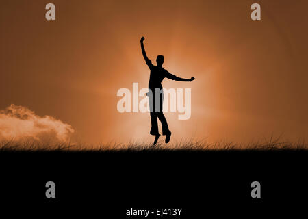 Composite image of silhouette of jumping woman Stock Photo