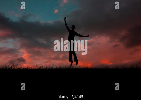 Composite image of silhouette of jumping woman Stock Photo