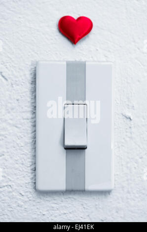close up of white light switch with a red heart above Stock Photo