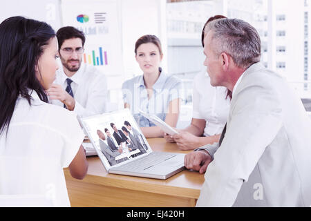 Composite image of business people disscussing a budget plan Stock Photo