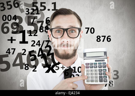 Composite image of geeky businessman pointing to calculator Stock Photo
