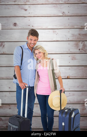 Composite image of attractive young couple ready to go on vacation Stock Photo
