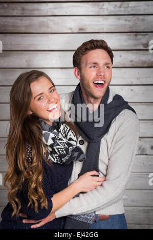 Composite image of happy young couple embracing Stock Photo