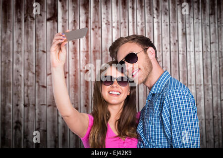 Composite image of couple taking selfie with smart phone Stock Photo