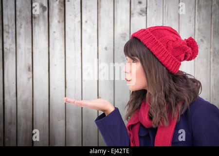 Composite image of festive brunette blowing a kiss Stock Photo