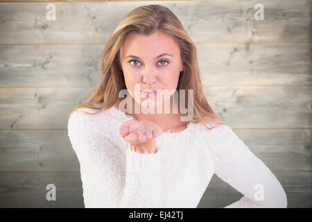 Composite image of pretty blonde blowing a kiss Stock Photo