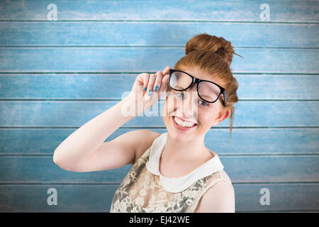 Composite image of hipster redhead smiling at camera Stock Photo