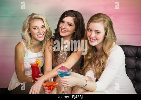 Composite image of friends drinking cocktails Stock Photo