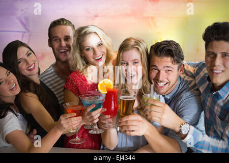 Composite image of friends drinking cocktails Stock Photo