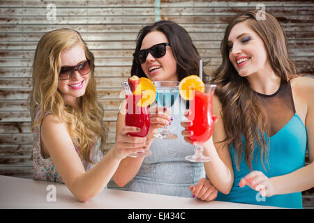 Composite image of friends drinking cocktails Stock Photo