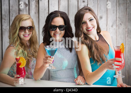 Composite image of friends drinking cocktails Stock Photo