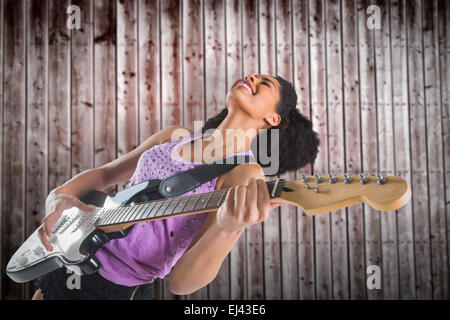 Composite image of pretty girl playing guitar Stock Photo