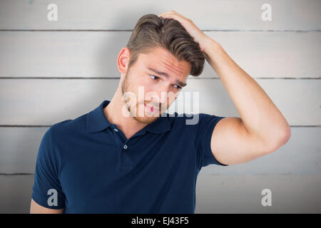 Composite image of handsome young man looking confused Stock Photo