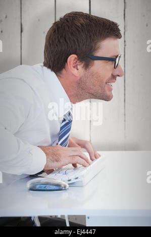 Composite image of business worker with reading glasses on computer Stock Photo