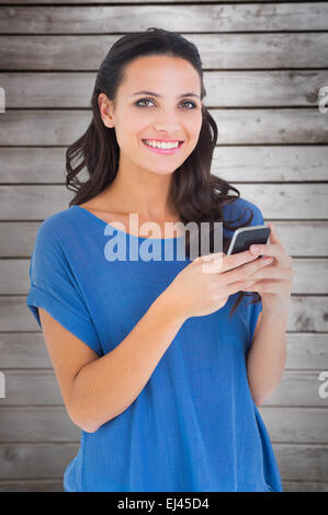 Composite image of pretty brunette sending a text Stock Photo
