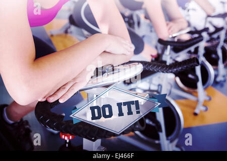 The word do it! and spin class working out in a row Stock Photo